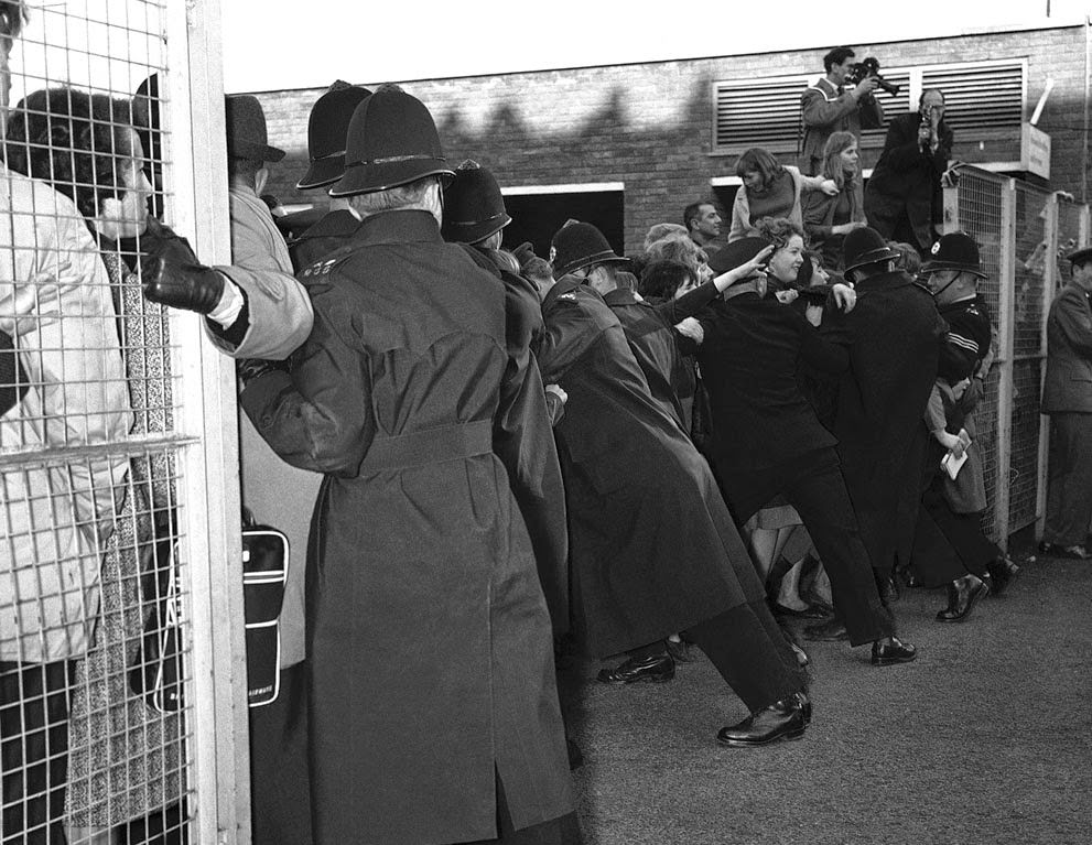 Police Hold Back Screaming Fans Fighting To Get Near The Beatles As The Liverpool Pop Group Returned To London Airport From Paris, February 5, 1964.