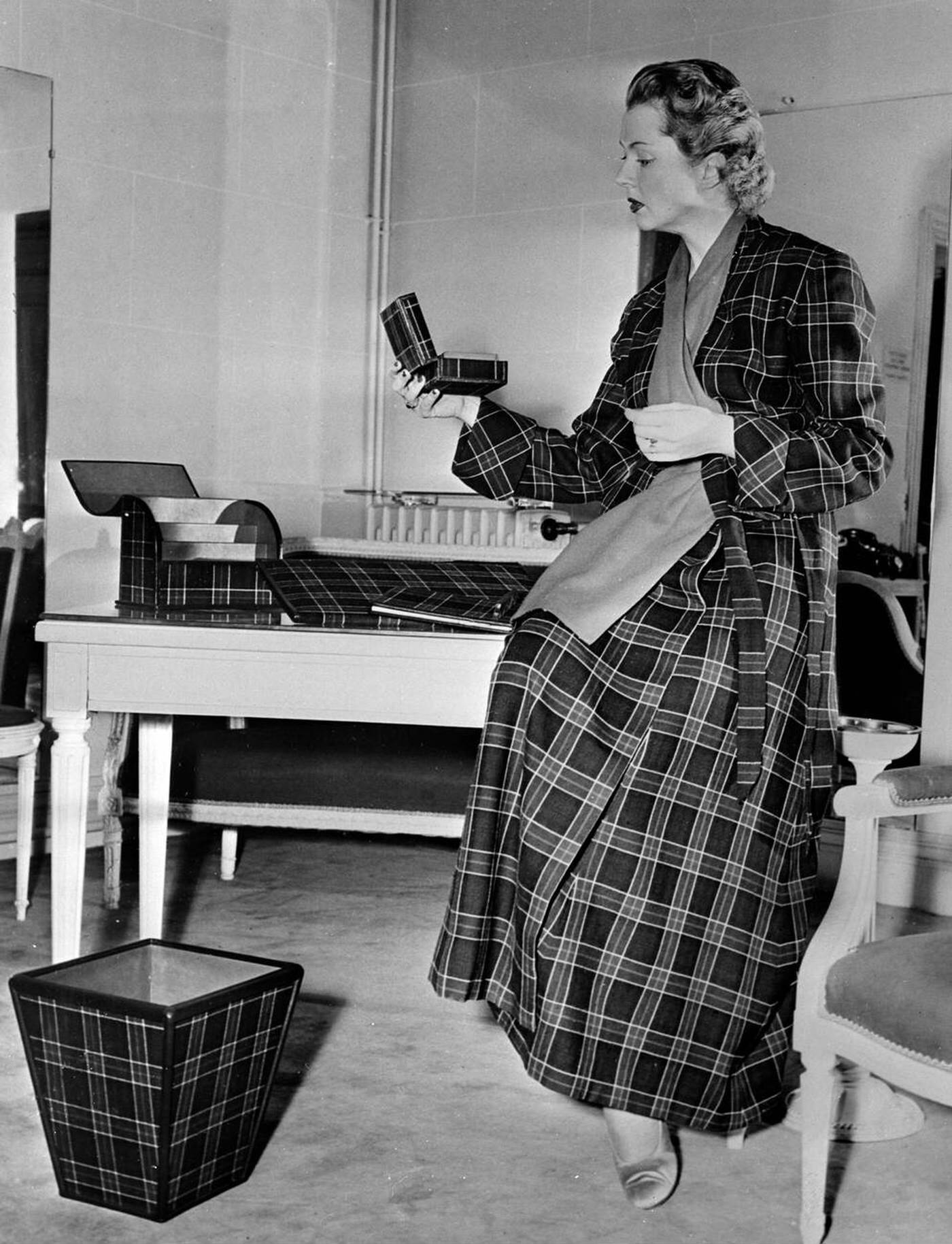 Christian Dior Has Created A Housecoat, For Man Or Woman, In Green Plaid, With A Complete Desk Set Consisting Of An Inkwell, Penholder, Calendar, And Blotter All Edged Or Covered To Match, 1950.