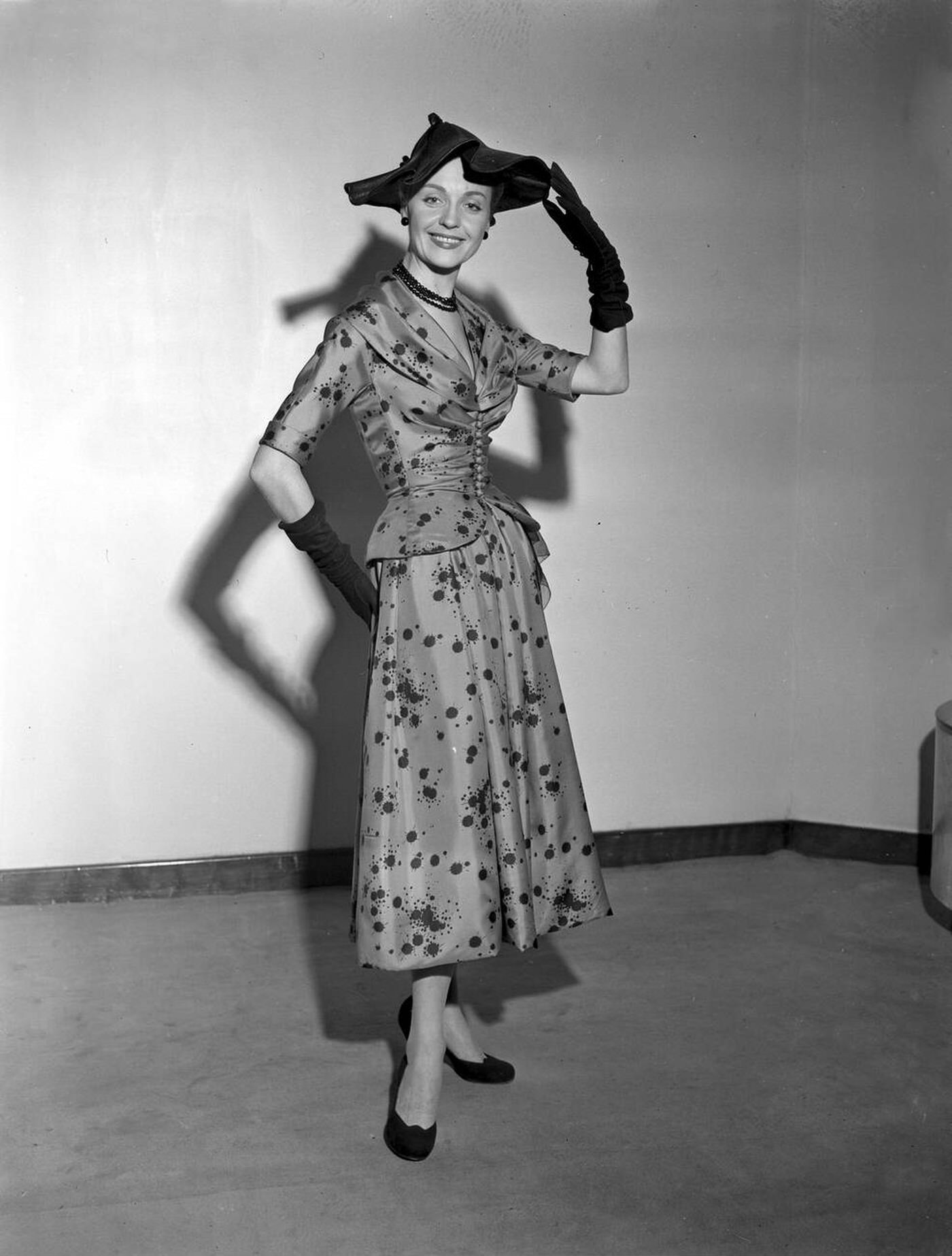 Dexter Vaughan Wears Perditta, A Red Silk Dress Featuring Novel Ink Spots, During A Showing Of The Spring Collection Of Christian Dior Models Made In England, 1952.
