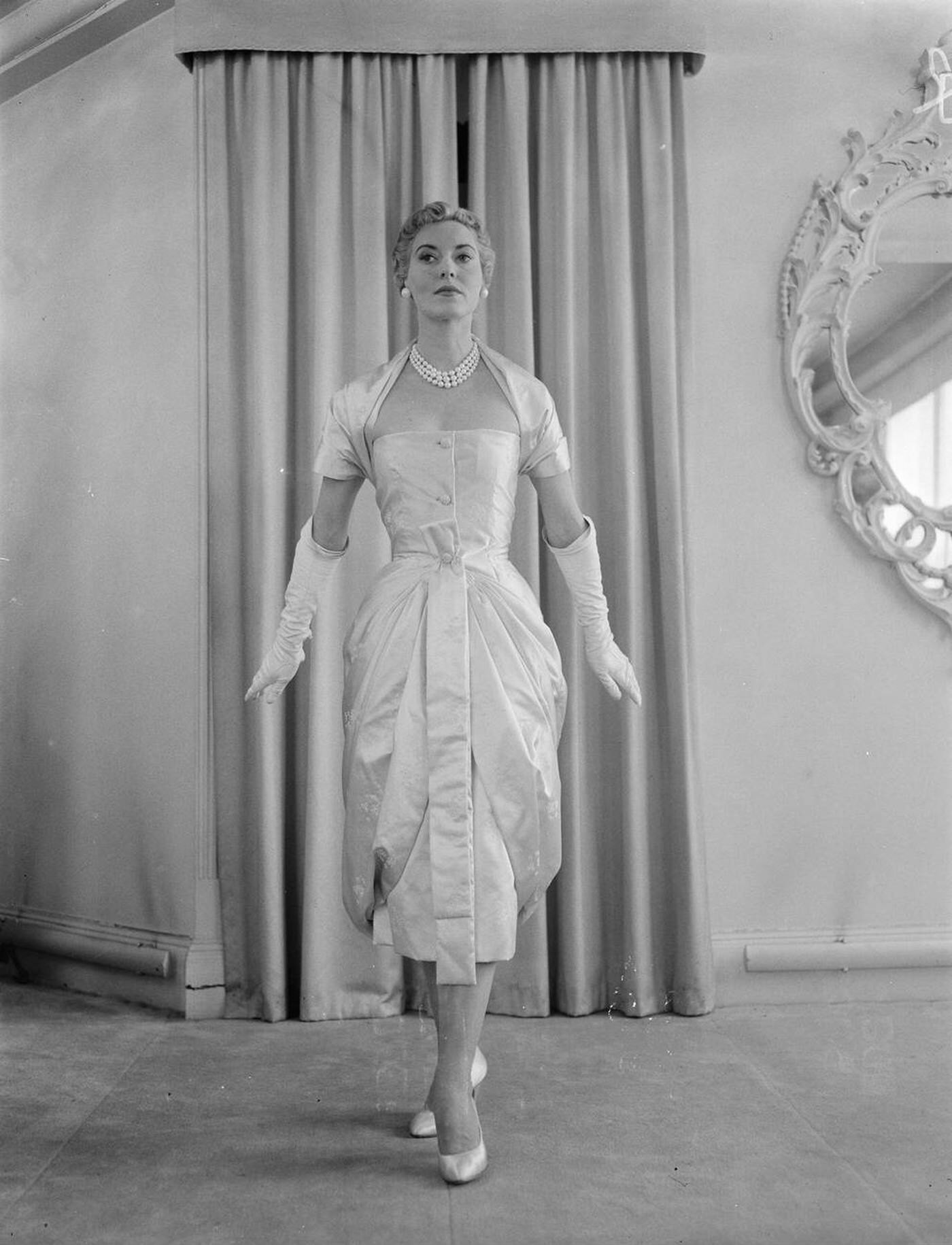 Gonconde, A Short Evening Gown In Pink Satin Trimmed With Silver Thread Embroidery, At The Christian Dior London Winter Mid Season Collection, 1955.