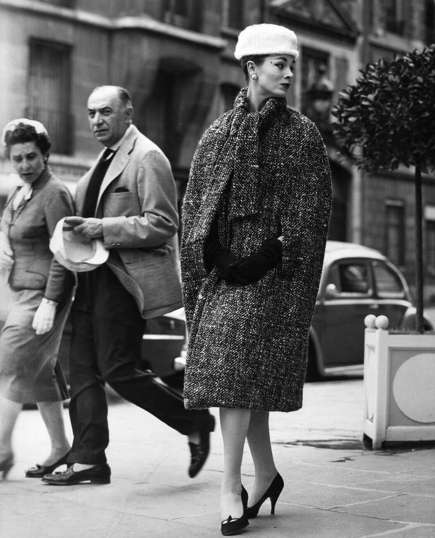 A Woman Wearing Tweed Cape And Sack Dress, Hat And Gloves By Christian Dior, 1956.