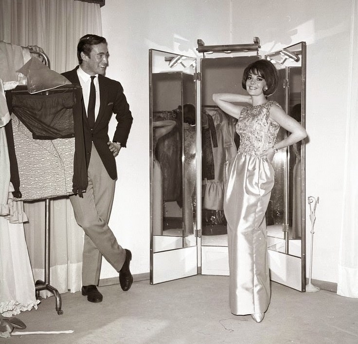 Natalie Wood Poses In An Evening Gown With David Niven Jr. Looking On, 1965.