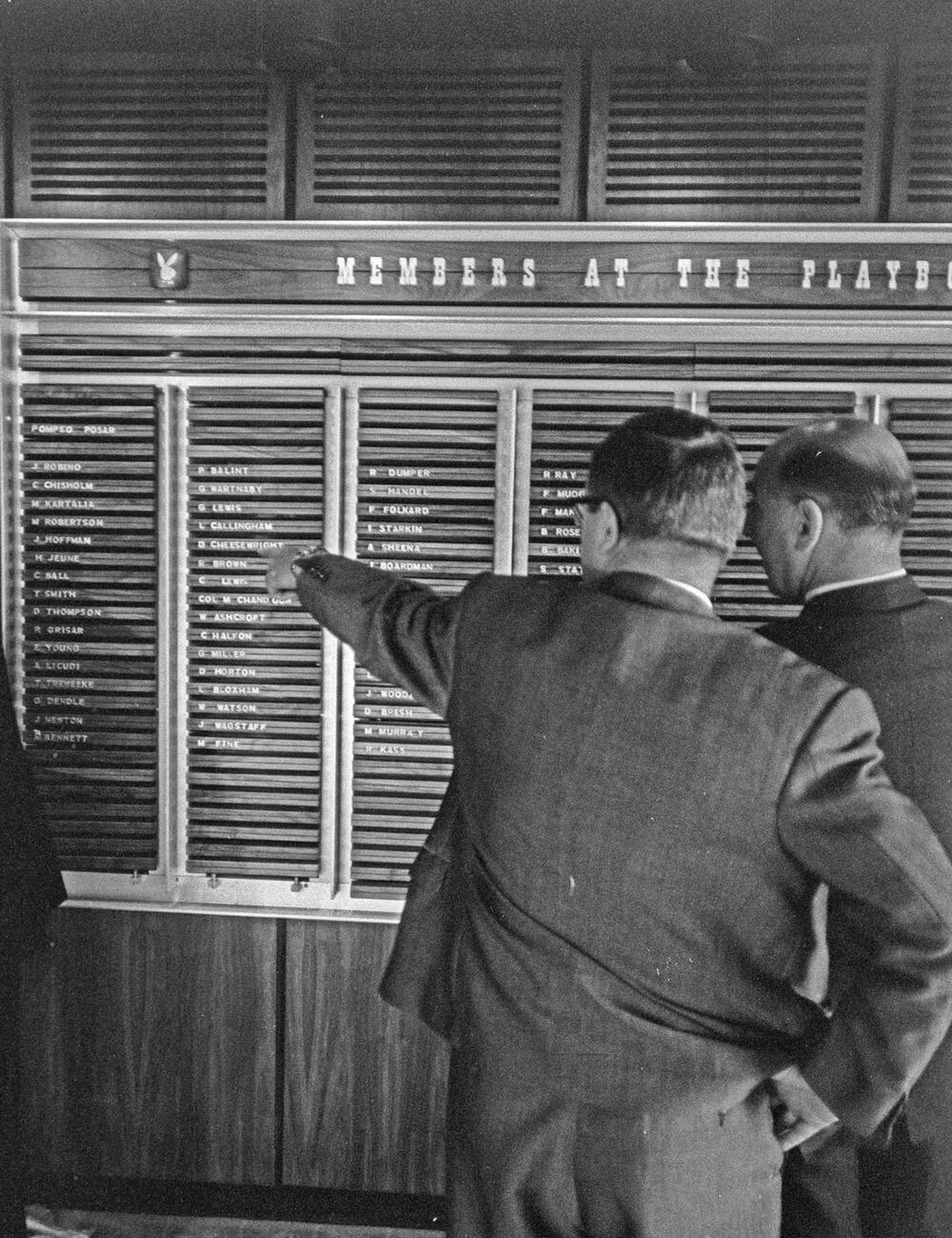Men Looking At Member List At Playboy Club London, 1966.