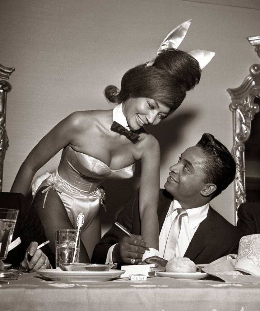 Jackie Wilson Autographs The Cuff Of A Playboy Bunny At A Dinner For The Motion Picture Pioneers Association At The Playboy Club In New York, 1962.