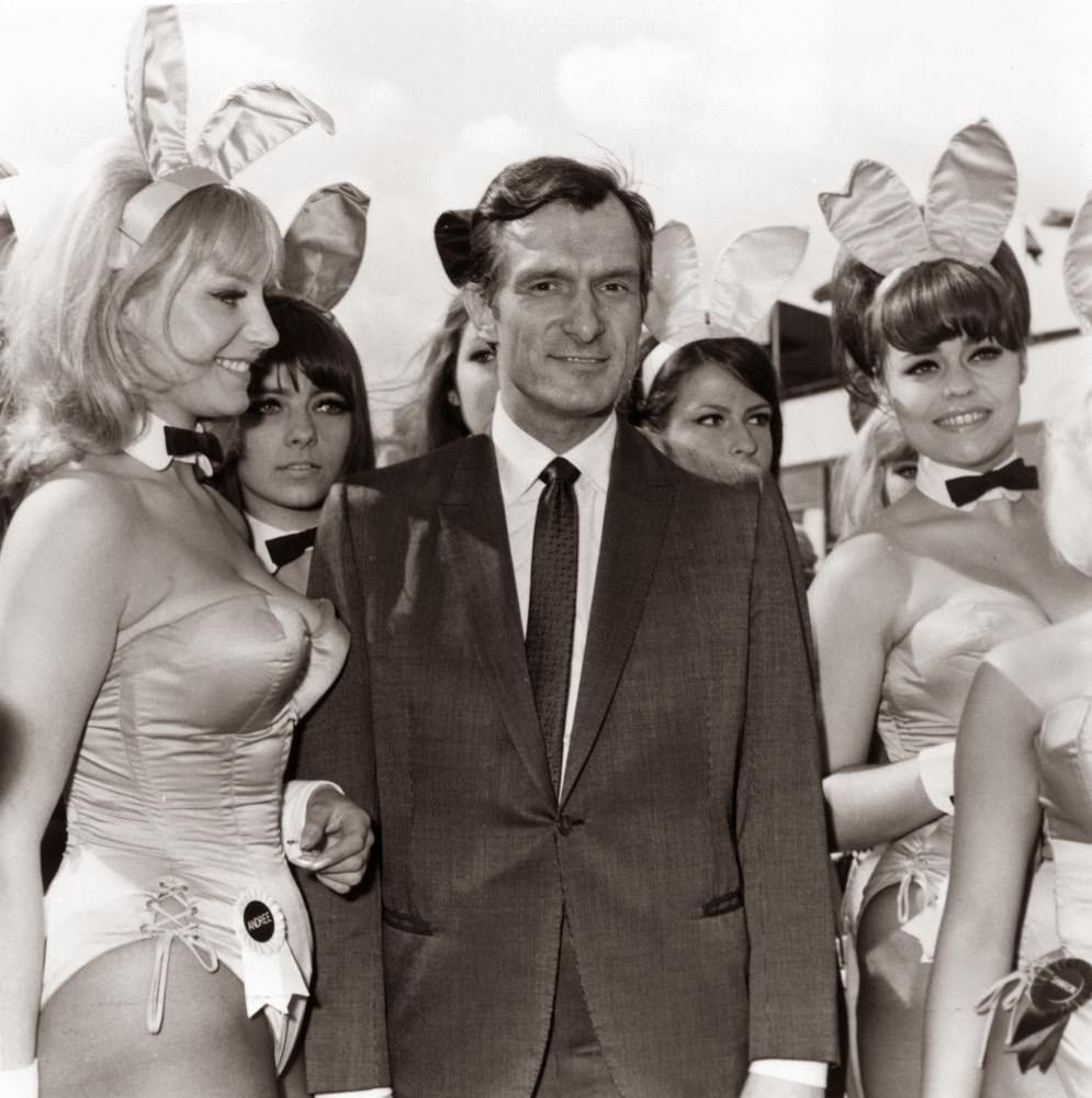 Hugh Hefner Is Greeted By Bunny Girls From His Playboy Clubs Upon His Arrival At London Airport.