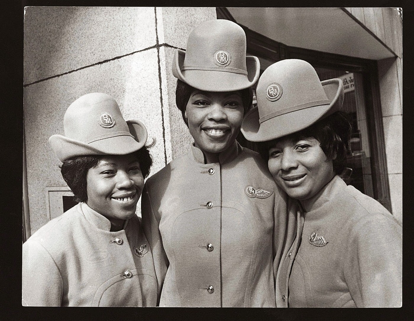 The First Uk-Based Non-White Stewardesses To Be Employed By An Independent Airline Received Their 'Wings' At The London Offices Of British Midland Airways: Innez Matthews, Irma Reid And Cindy Medford, 1970.