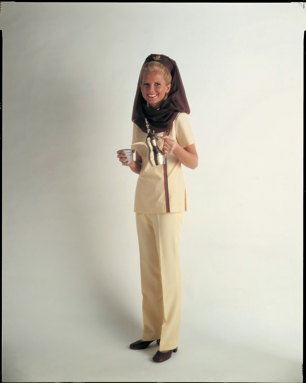 Middle East Meets West In The 1970S With Gulf Air'S Adaptation Of The Muslim Headdress; Legs Are Covered By Smart Trousers.