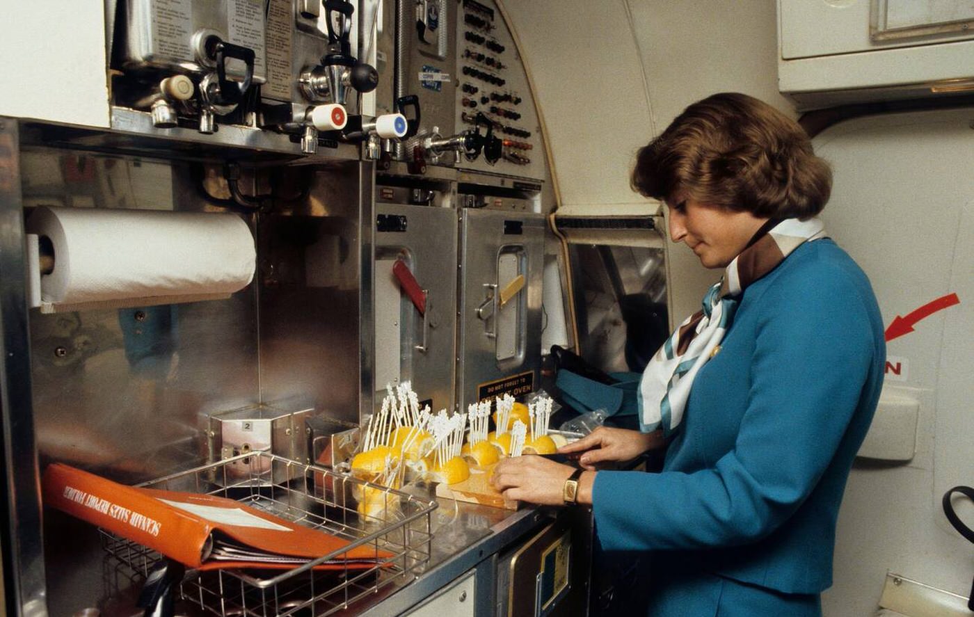 A Swedish Passenger Airplane Of The Airline Sas; The Flight Attendants Is Preparing Drinks In The Cabin, 1979.