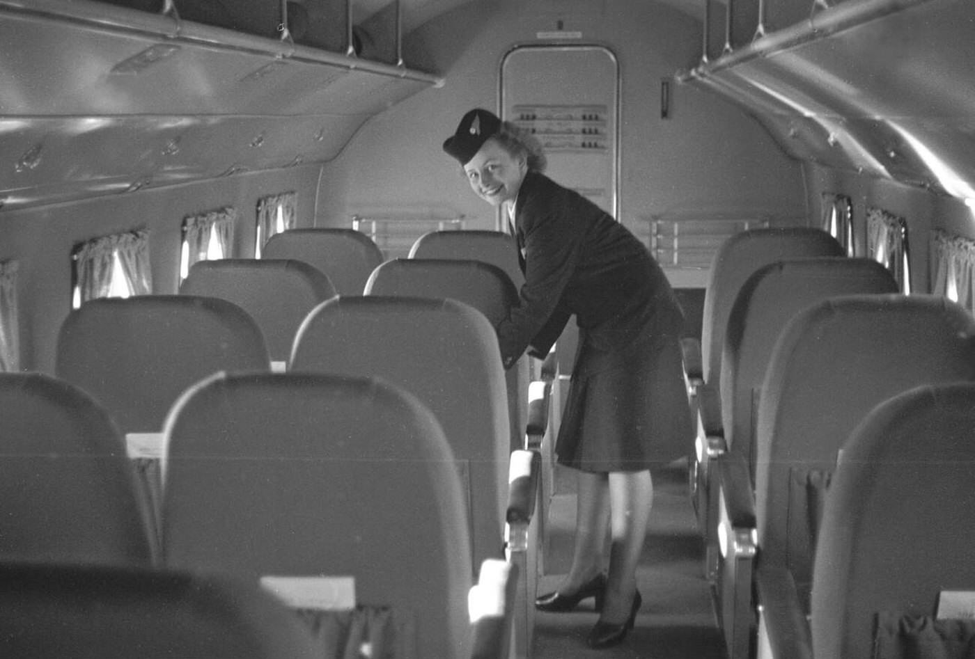 Flight Attendant At Work Prepares The Flight Seats Before Passengers Board The Plane At Fornebu Airport, Oslo, 1946.