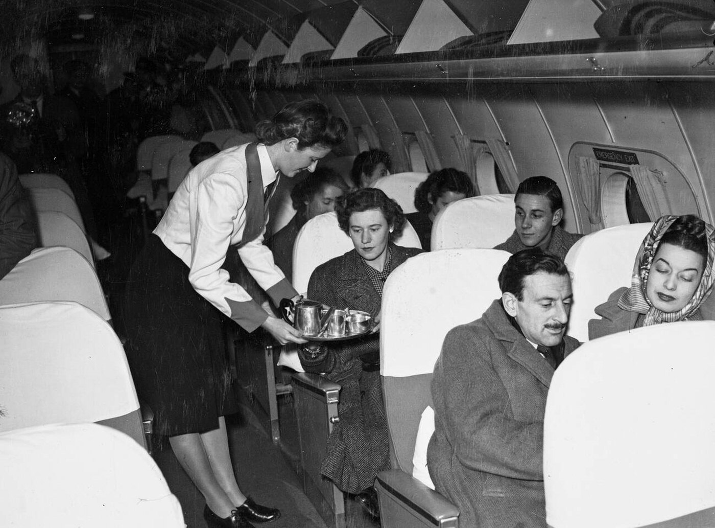 Miss Janet Huntley, The First Of The British Overseas Airways Corporation Stewardesses To Fly On Duty To New York, Serving Refreshments To Passengers On The Constellation Aircraft About To Take Off, 1946.