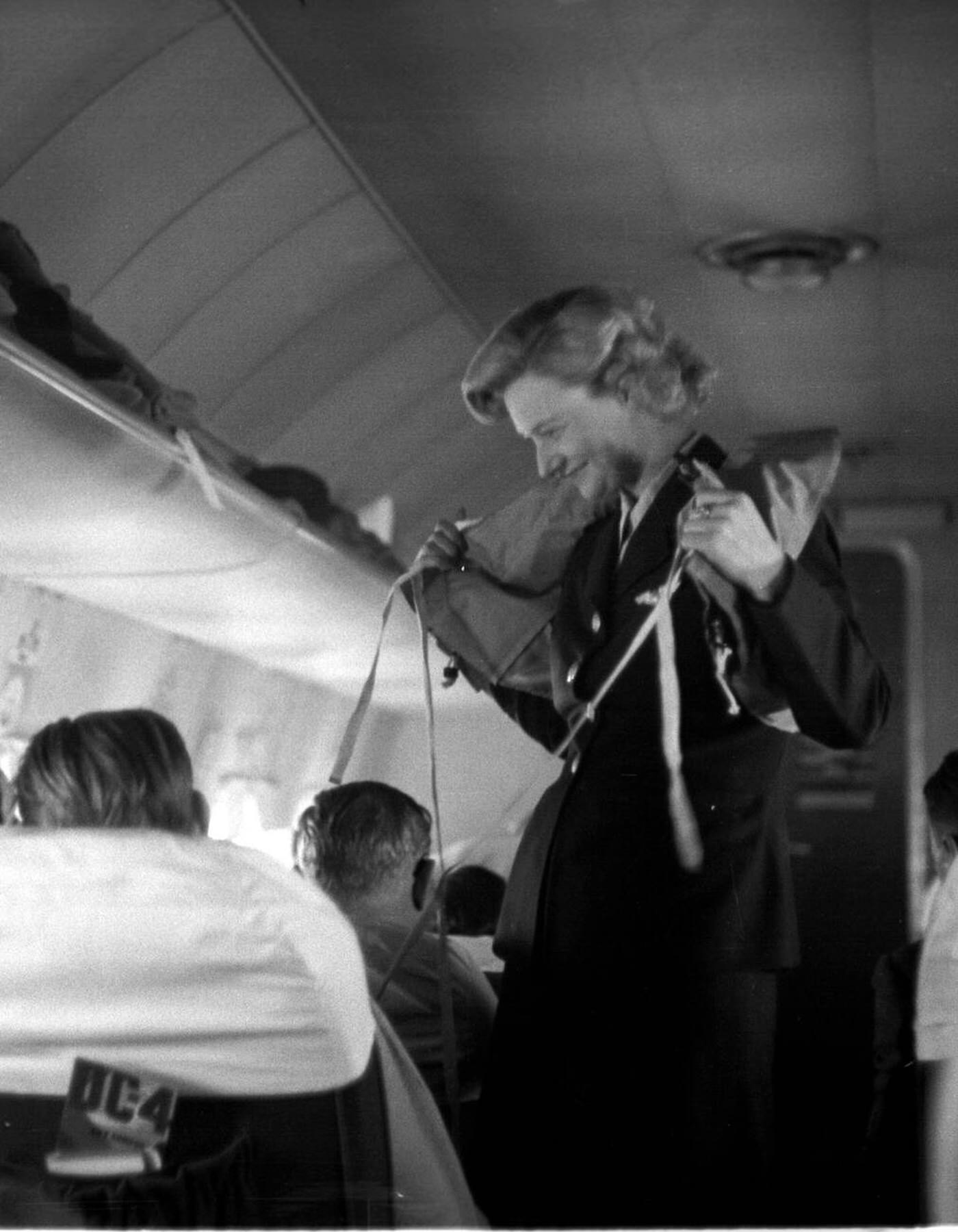 A Flight Attendant Demonstrates Life Jackets And Other Security Procedures, Sas Flyrute Copenhagen / New York, 1948.