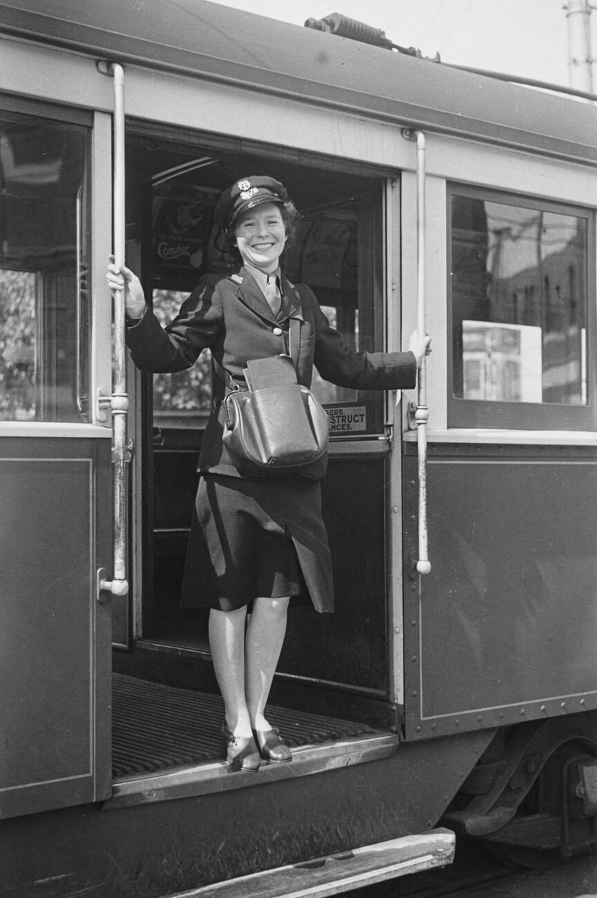 Woman Ticket And Fare Collector Standing In The Doorway Of A Streetcar In Melbourne, 1944