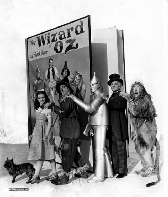 Judy Garland As Dorothy Gale, Ray Bolger As The Scarecrow, Jack Haley As The Tin Man, Frank Morgan As The Wizard, Bert Lahr As The Cowardly Lion And Terry As Toto With An Oversized Prop Book Of &Amp;Quot;The Wizard Of Oz.&Amp;Quot;