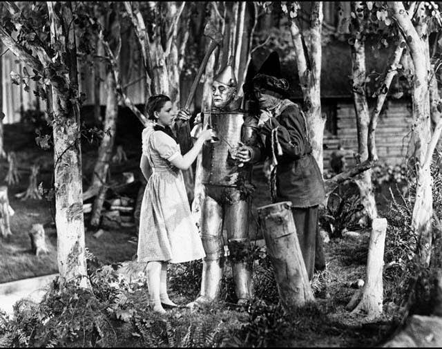 Judy Garland As Dorothy Gale And Ray Bolger As The Scarecrow, With Jack Haley As The Tin Man During A Rehearsal.