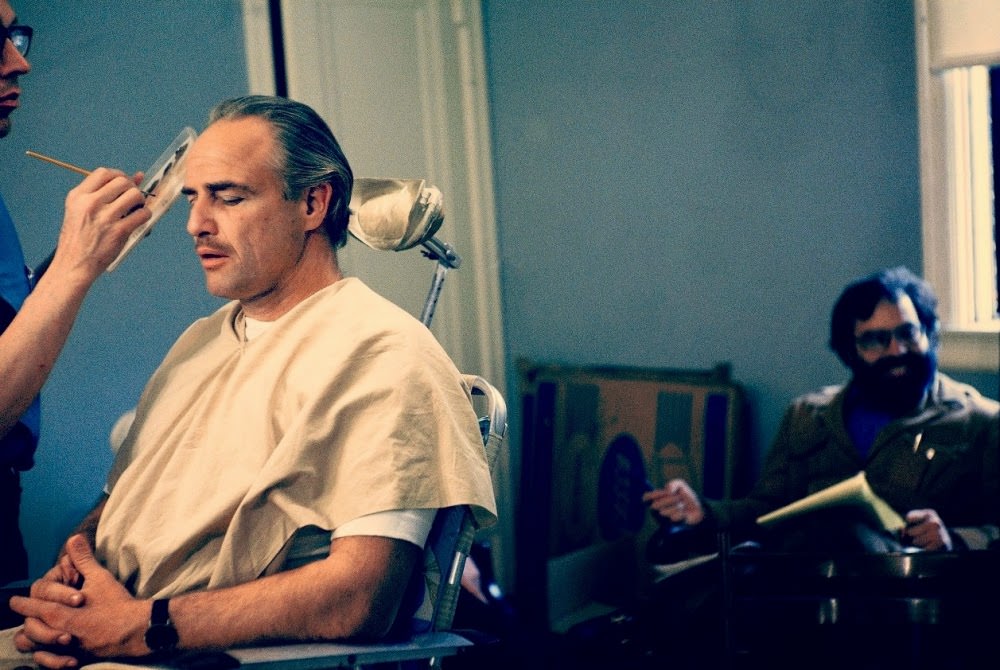Marlon Brando Gets Made Up As Mafia Family Patriarch Don Corleone In The Godfather (1972), While Director Francis Ford Coppola Waits In The Background.