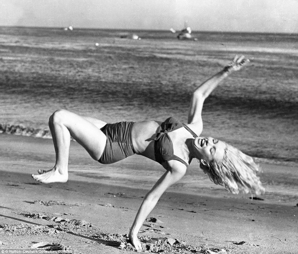 Marilyn Monroe Takes A Break From Filming In The 1950S To Frolic On An La Beach.