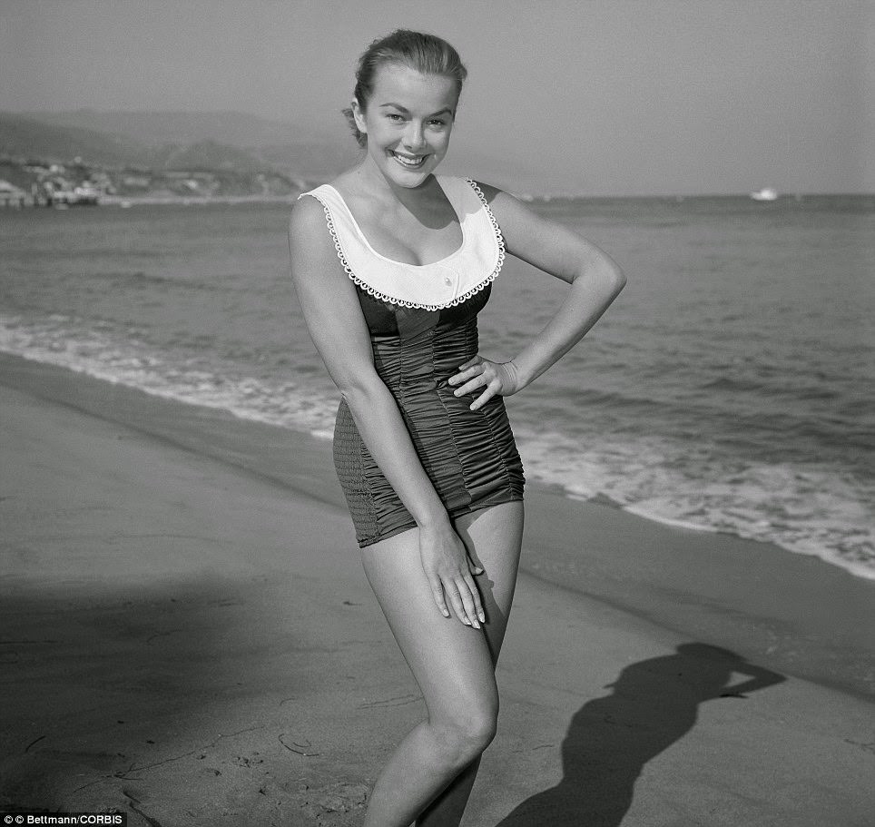 Marjorie Helen Models A White Pique Collar Swimsuit Trimmed In Lace And Set Off With A Pearl, On An La Beach In 1956.