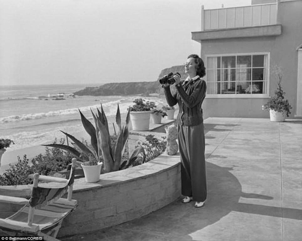 Merle Oberon Keeps A Close Eye On Beach Activities With Binoculars From Her Home On Tranca Beach Home In 1948.