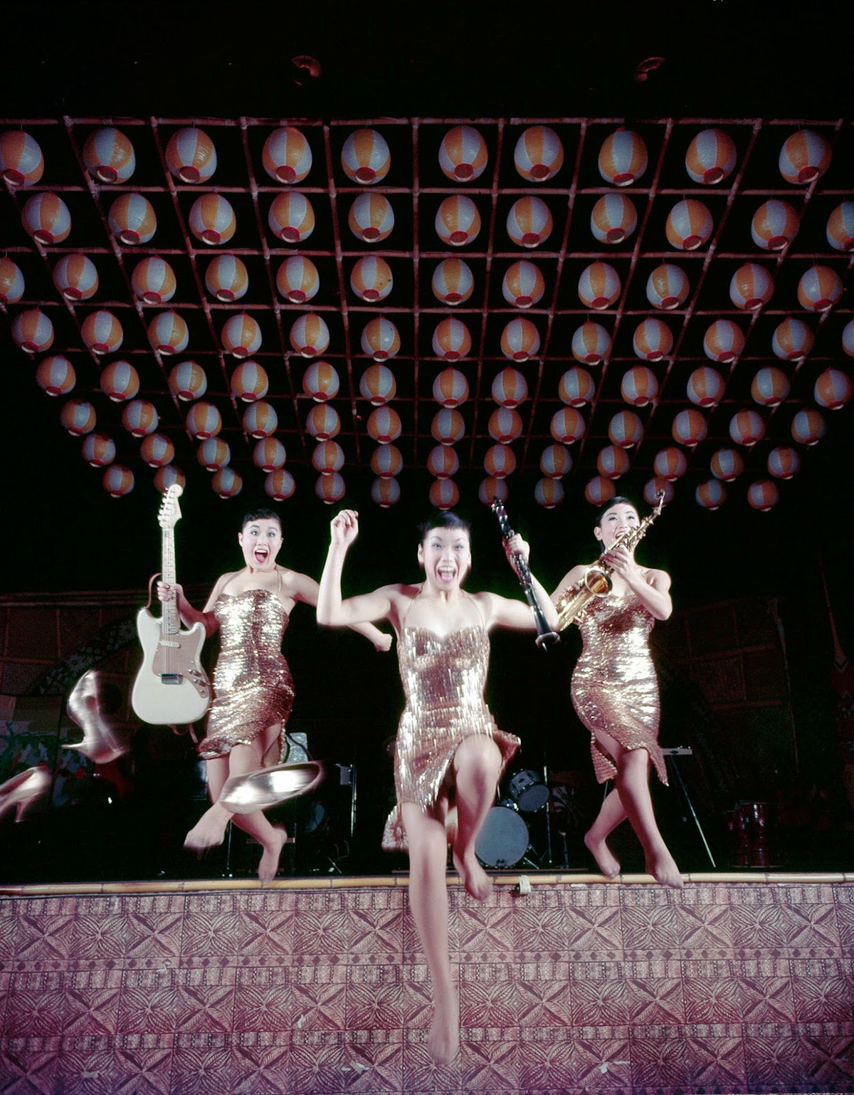 Split-Sheathed Singers, Min Ja (With Guitar), Sook Ja (With Clarinet) And Ai Ja (With Saxophone) Leap Off The Stage After Performing 'Five Foot Two.' The Trio Plays 10 Instruments, Including A Bass Fiddle And A Banjo.