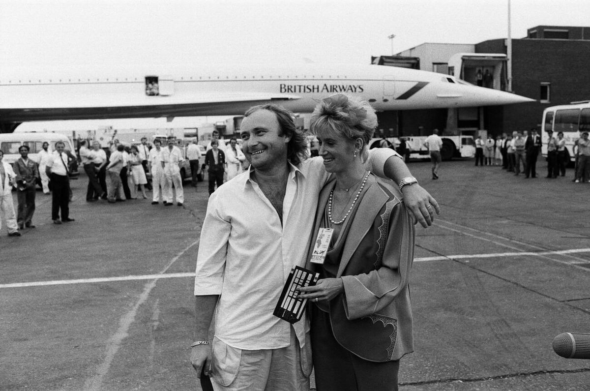 Phil Collins And Jill Tavelman At London Heathrow Airport Before A Flight To The Us For Live Aid, 1985