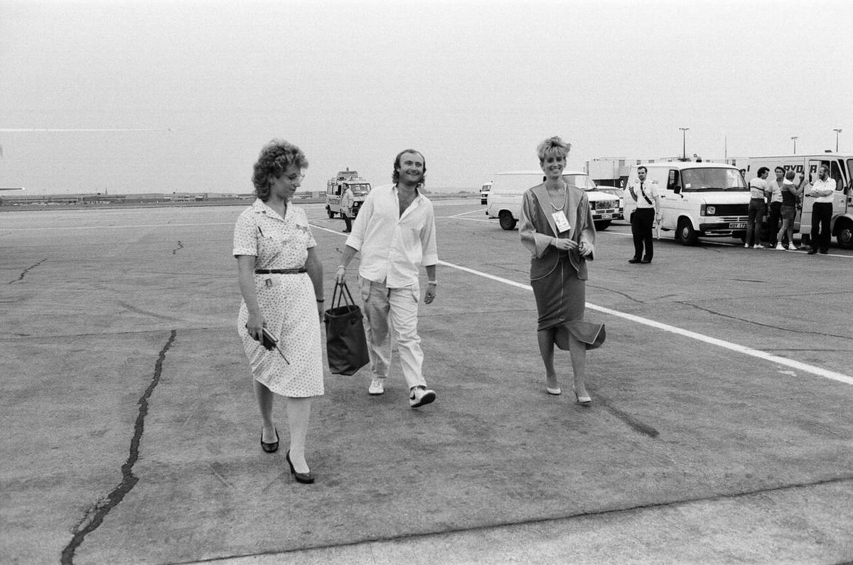Phil Collins And Jill Tavelman At London Heathrow Airport Before A Flight To The Us For Live Aid, 1985