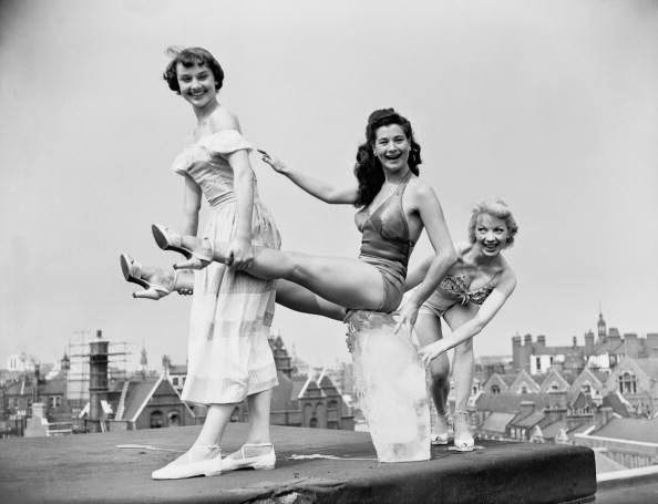 Chorus Girls Audrey Hepburn, Aud Johanssen, And Enid Smeedon From The Show Sauce Tartare Keep Cool With A Block Of Ice On The Roof Of The Cambridge Theatre In London. June 28, 1949.