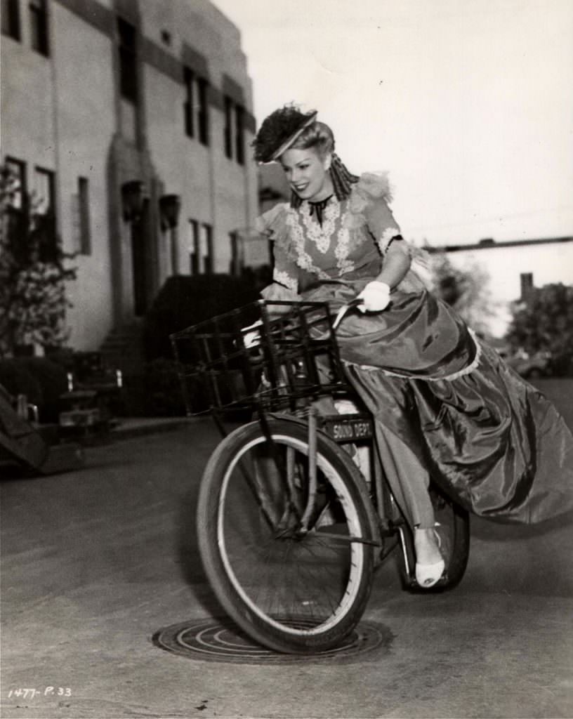 Ann Fredericks Riding A Sound Department Bicycle.