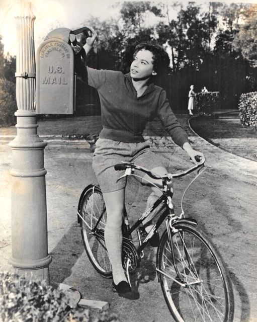 Leslie Caron Rides A Bike, Mails A Letter