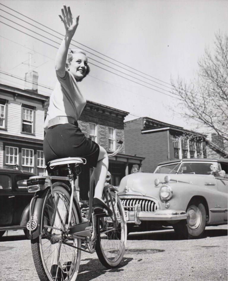 Jan Sterling Riding A Bicycle And Waving, 1951.